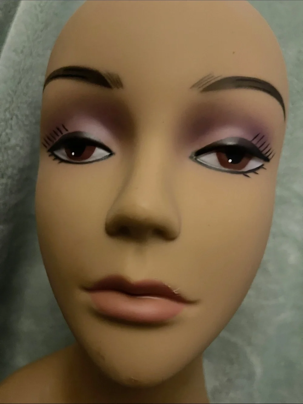 Tan Female Mannequin Head with Purple Makeup